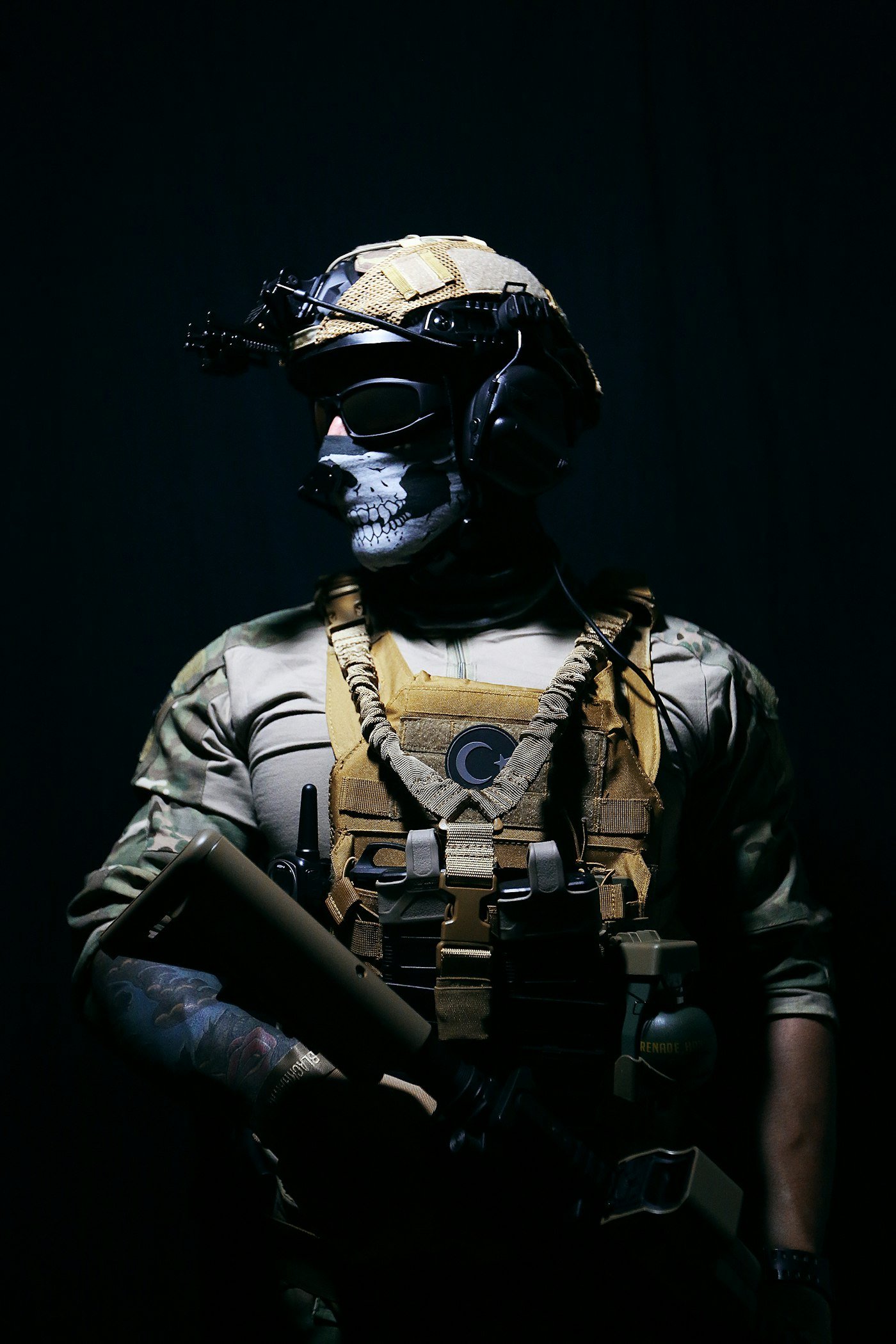 a man in a helmet and goggles holding a gun